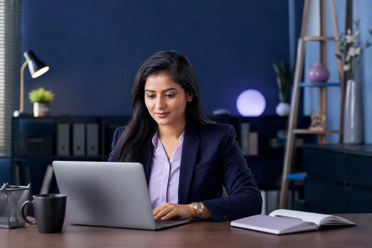 Indian professional working securely on a laptop in a private office